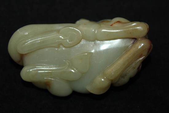 A Chinese celadon and brown jade figure of a recumbent horse, 20th century, 9.5cm